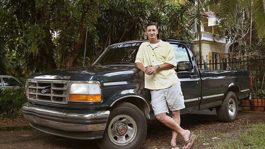 A man standing next to his Ford F-150 truck
