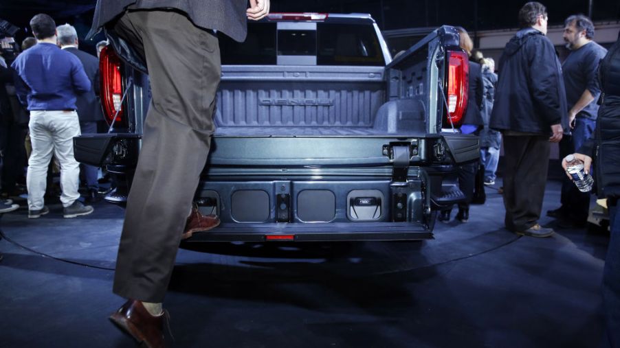 A man demonstrating how to use the new tailgate system in the GMC Siera