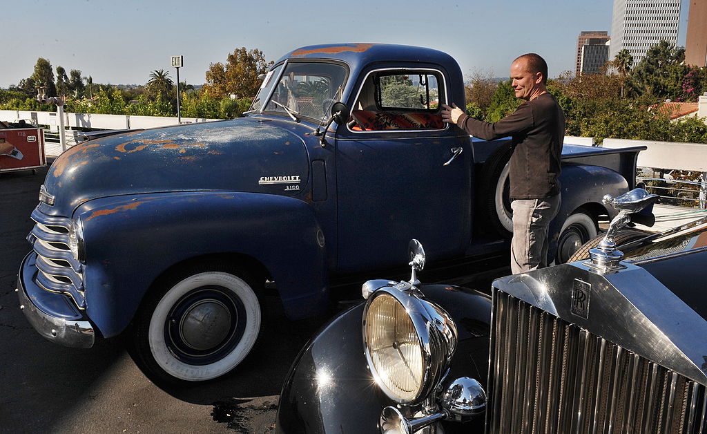 An employee of Auctioneer Bonhams and Butterfields, looks at the 1949 Chevrolet 3100 pick-up truck that was owned by actor Steve McQueen and is on display at the upcoming "Classic California" car and bike auction in Los Angeles on November 13, 2009. AFP PHOTO/Mark RALSTON (Photo credit should read MARK RALSTON/AFP via Getty Images)