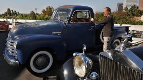 An employee of Auctioneer Bonhams and Butterfields, looks at the 1949 Chevrolet 3100 pick-up truck that was owned by actor Steve McQueen and is on display at the upcoming "Classic California" car and bike auction in Los Angeles on November 13, 2009. AFP PHOTO/Mark RALSTON (Photo credit should read MARK RALSTON/AFP via Getty Images)