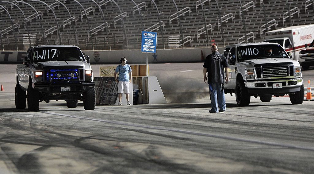 FORT WORTH, TX - JUNE 22:  Race starter Scott Garrett watches as two Ford diesel pickup trucks leap off the starting line during Scion Friday Night Drags at Texas Motor Speedway on June 22, 2012 in Fort Worth, Texas. (Photo by Brandon Wade/Getty Images for Texas Motor Speedway)