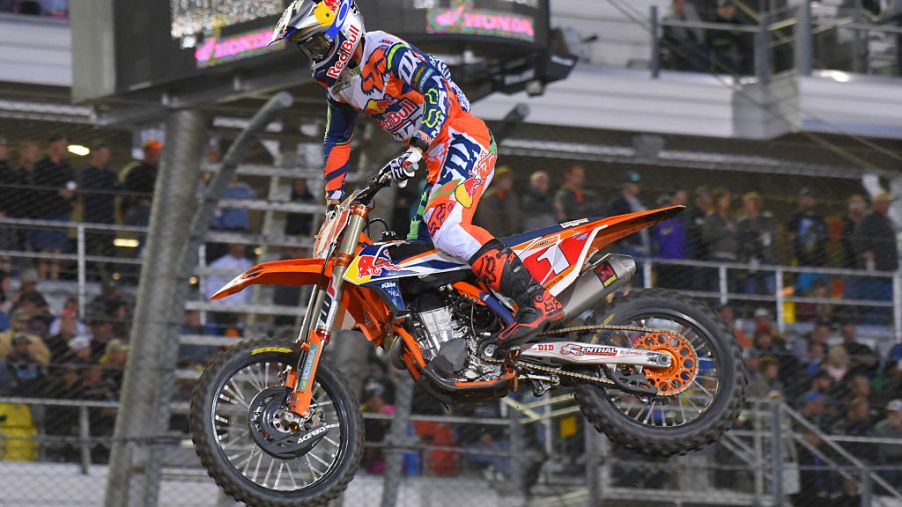 The fastest dirt bike in the world, the KTM 450 SX-F hitting a jump.