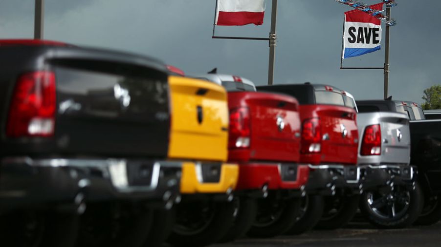 A line of trucks for sale at a car dealership.