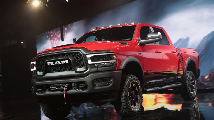 A red Ram pickup truck on display at an auto show.
