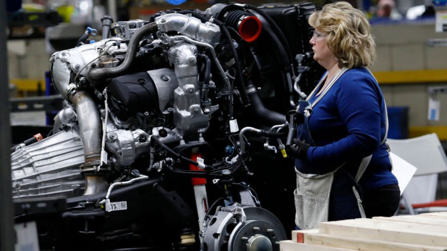 The Silverado and Sierra truck engine is inspected by a GM worker.