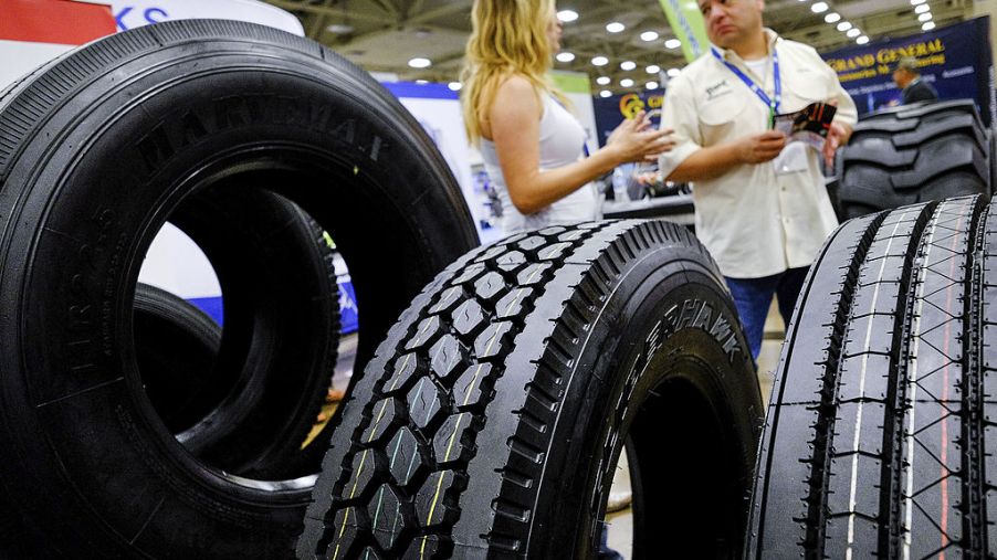 Truck tires sit on display during a car and truck show