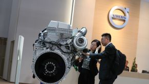 Attendees inspect a Volvo AB diesel truck engine