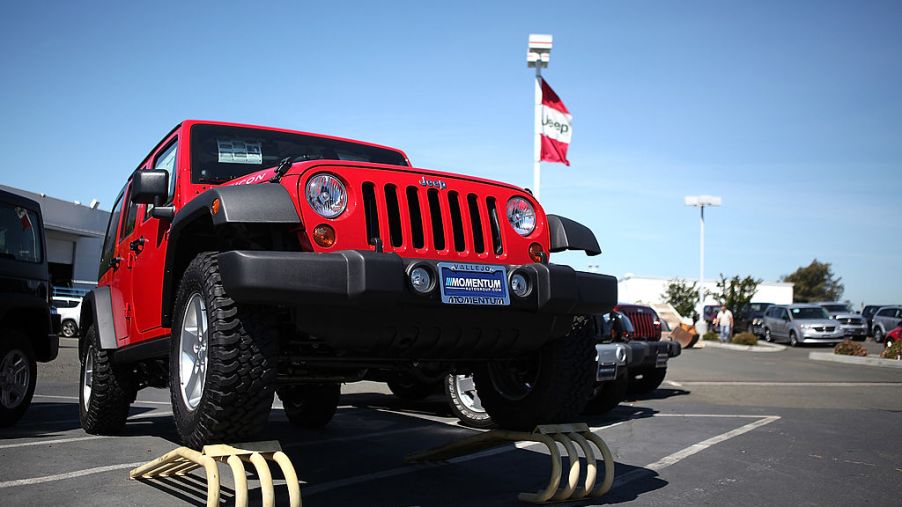 A used Jeep Wrangler for sale at a car dealership.