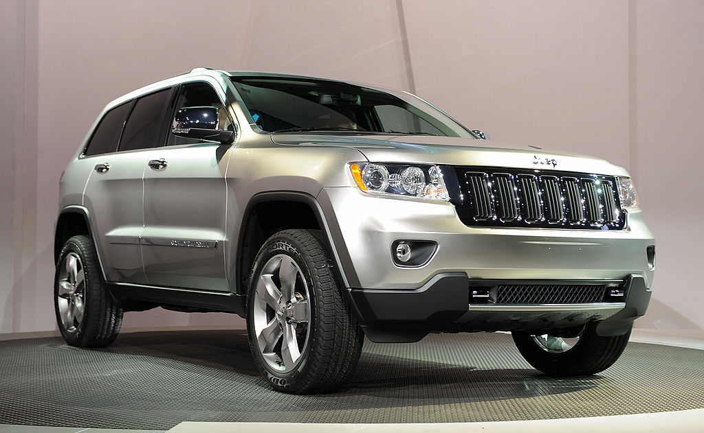 A 2011 Jeep Grand Cherokee on display at an auto show.