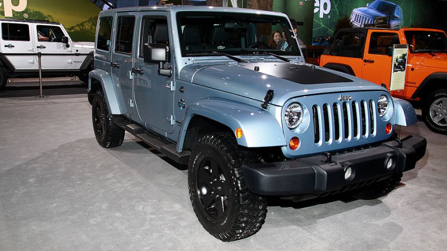 A 2012 Jeep Wrangler on display at an auto show.