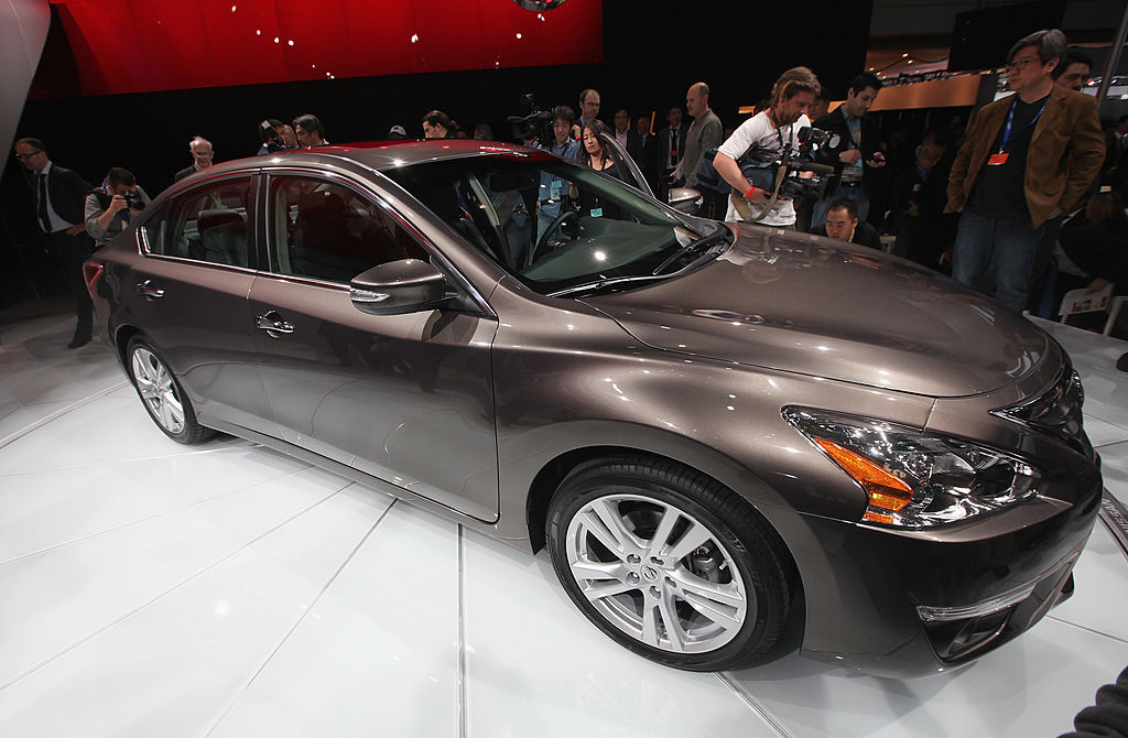 A 2013 Nissan Altima on display at an auto show.