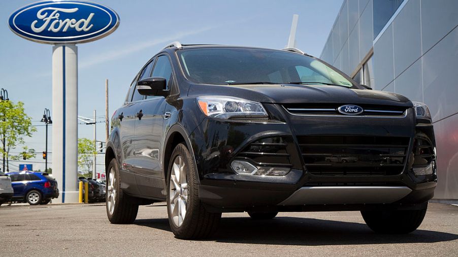 A 2014 Ford Escape on a car dealership lot.
