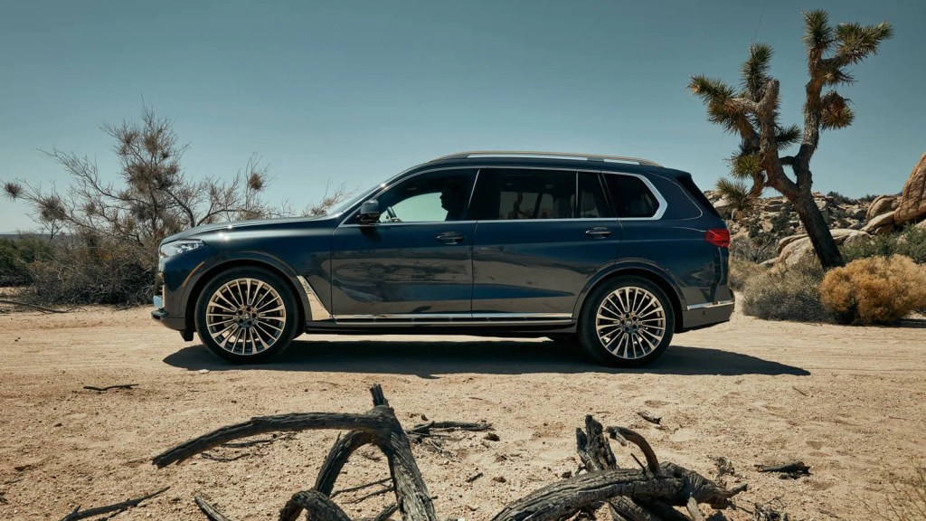 A side-view of the 2020 BMW X7 parked in the sand.