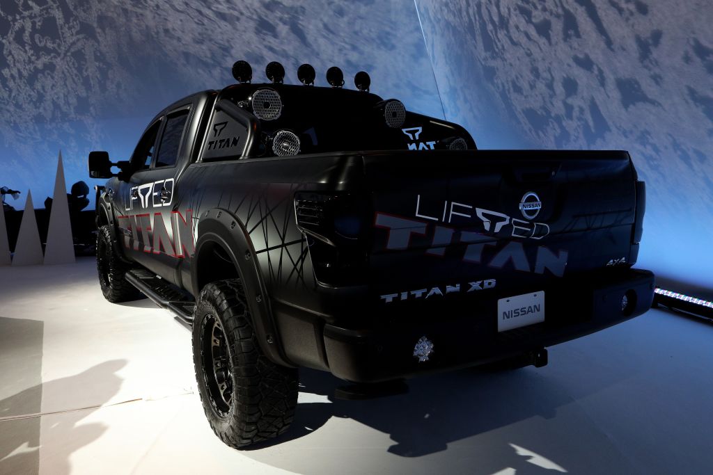 A black Nissan Titan on display at an auto show
