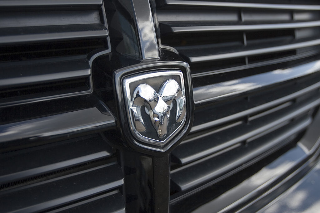 The Dodge emblem on the front of a black pick-up truck