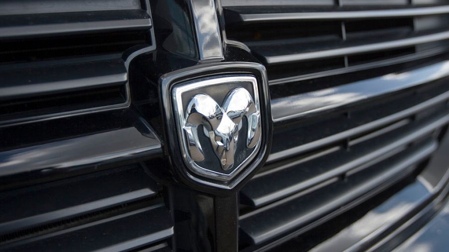 The Dodge emblem on the front of a black pick-up truck
