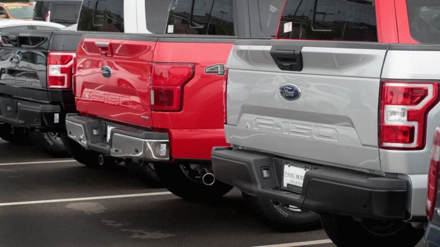 Ford F-150 full-size trucks on a sales lot.