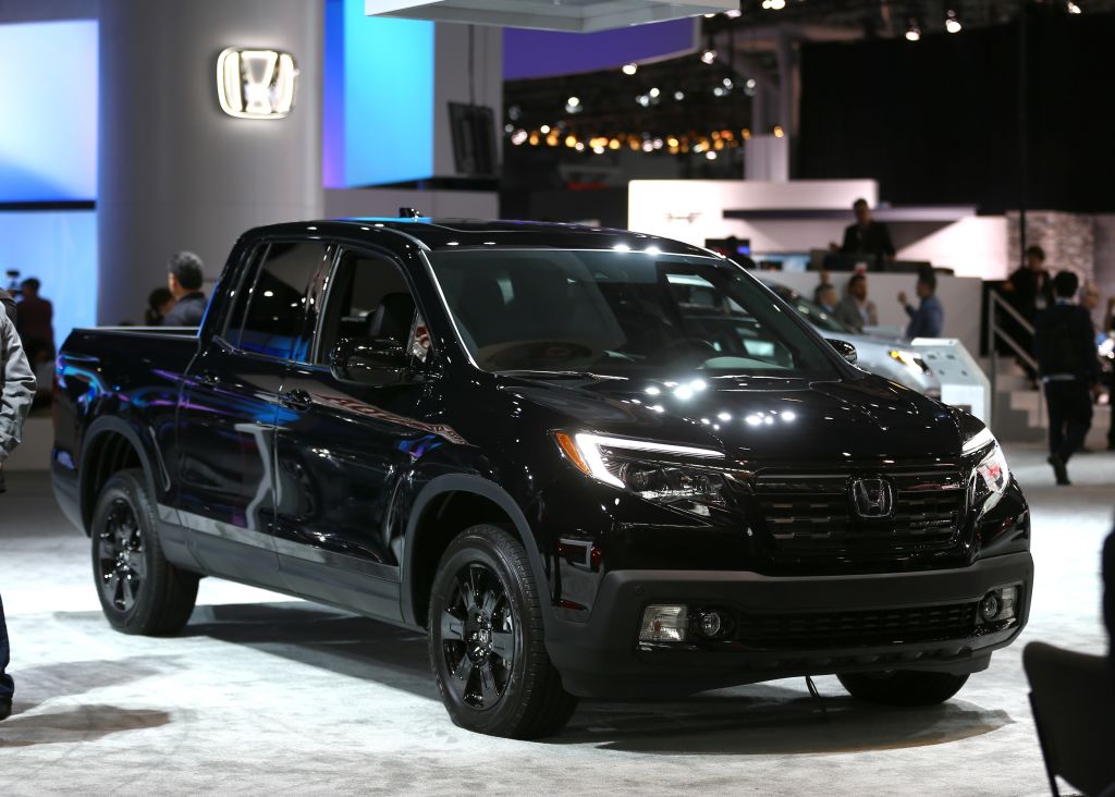 A Honda Ridgeline truck on display at an auto show.