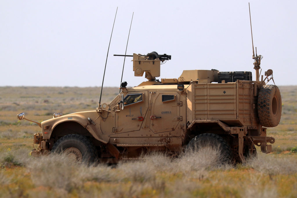 A JLTV U.S. military truck driving in the desert.