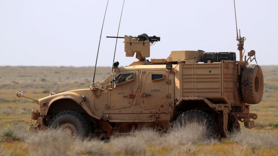 A JLTV U.S. military truck driving in the desert.