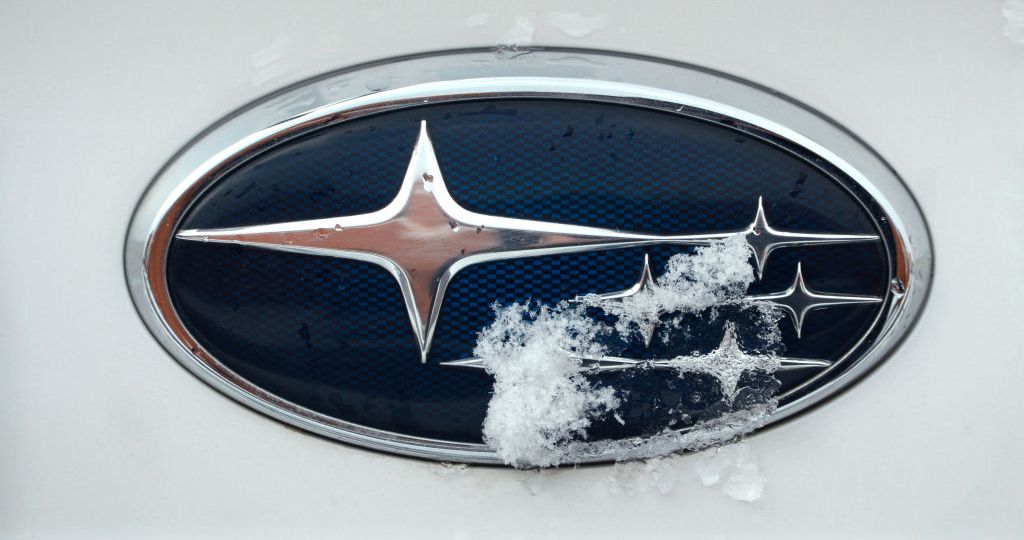 A Subaru logo on the front of a white car