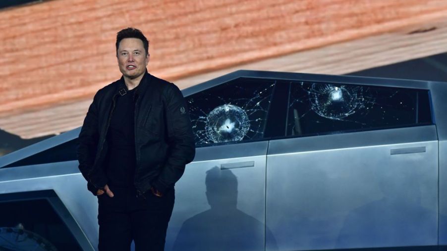 Elon Musk standing in front of a Tesla Cybertruck
