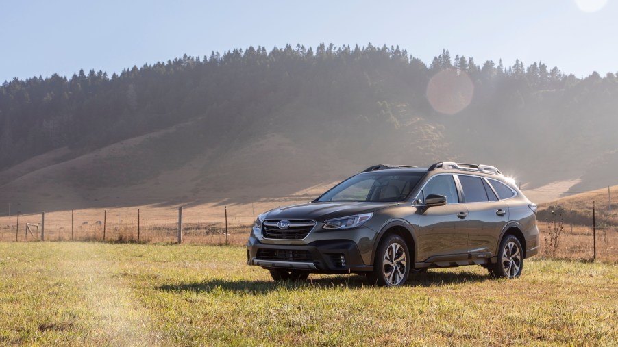 2020 Subaru Outback AWD SUV parked in a green field