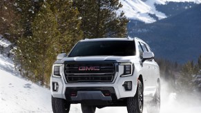 2021 GMC Yukon AT4 driving down icy road