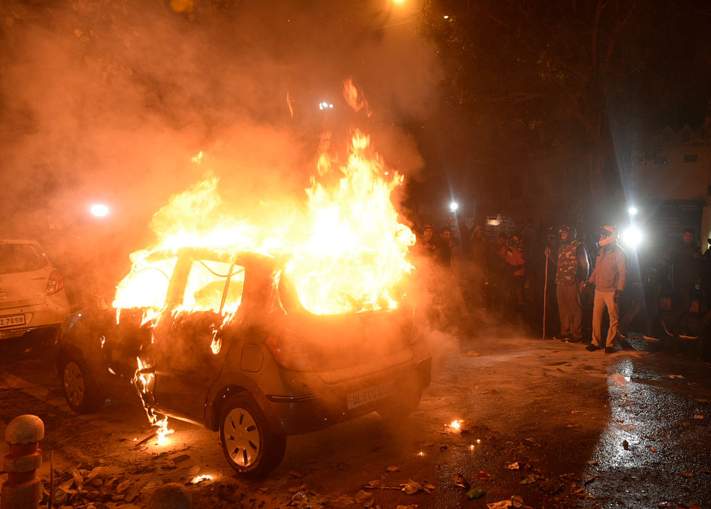 A car on fire in New Delhi, India
