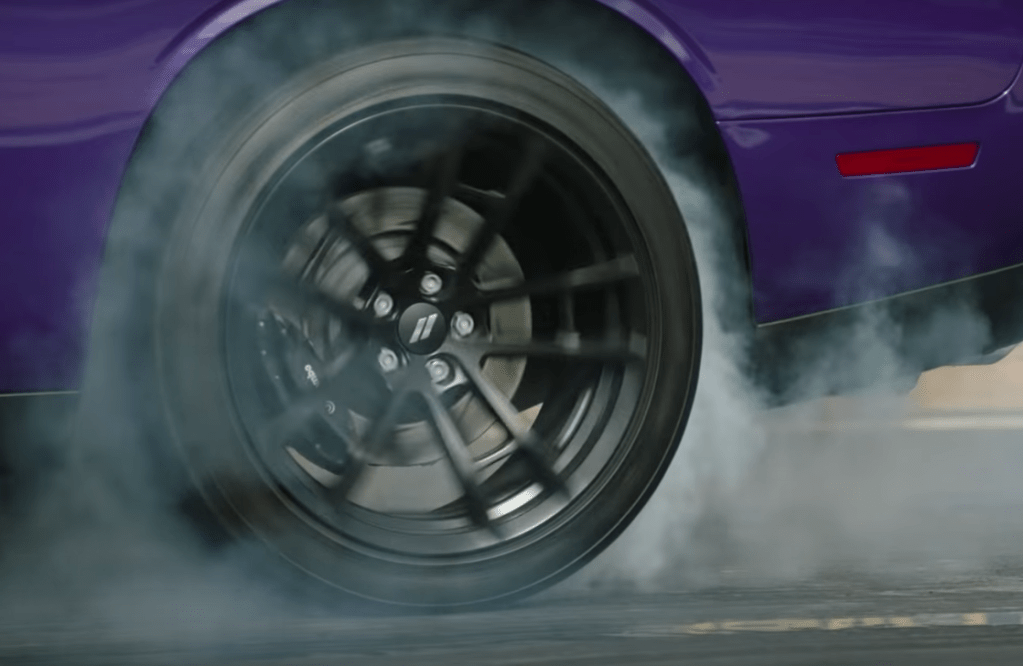 A Dodge Challenger burnout with smoke rising | FCA