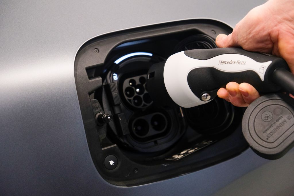 A plug going into an electric car