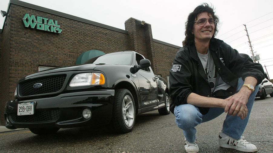 A fan poses next to a Ford SVT Lightning