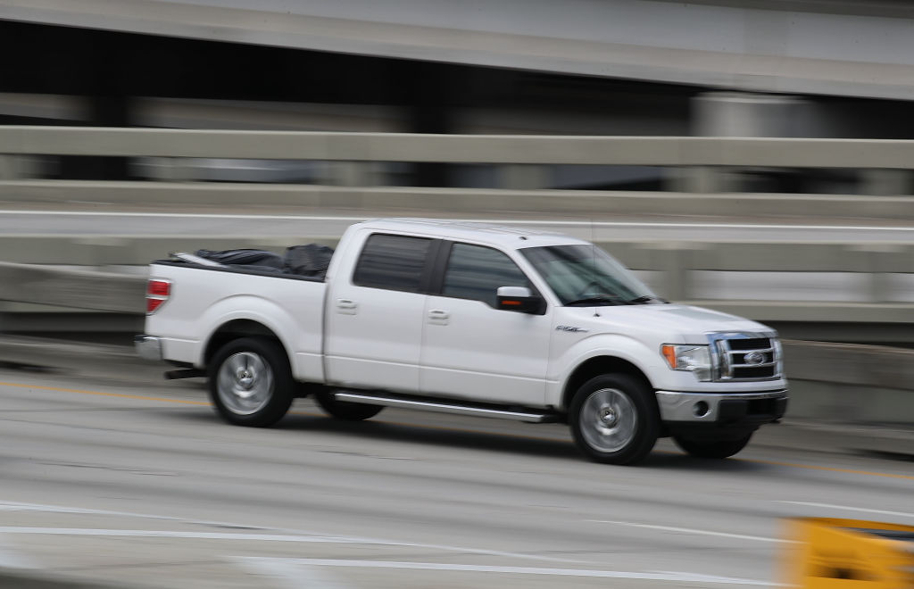 Ford pickup truck drives on a road in Miami
