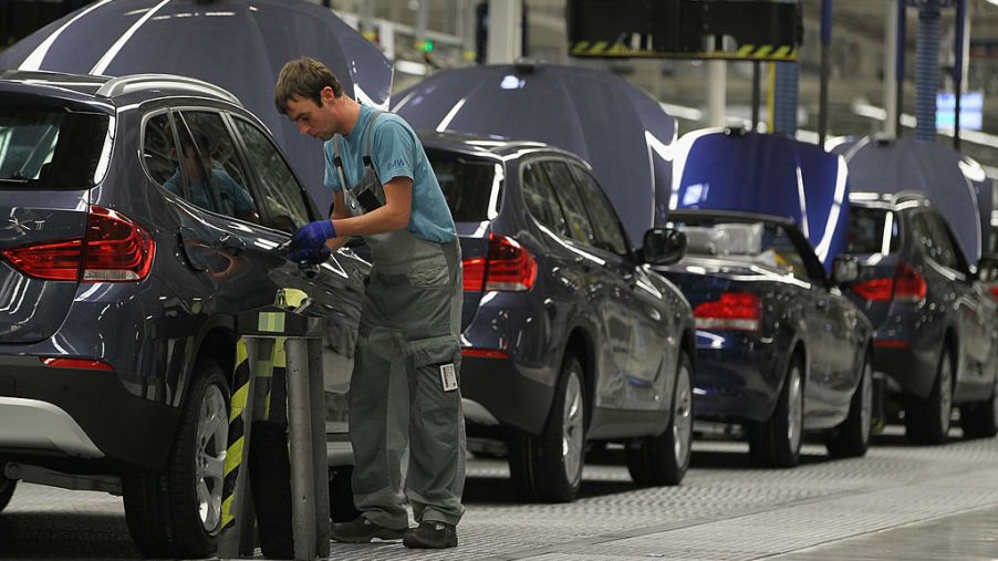 German workers assemble BMW cars at a factory