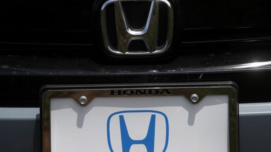 The Honda logo on a new car