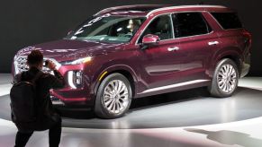 A man snaps a photo of a Hyundai Palisade