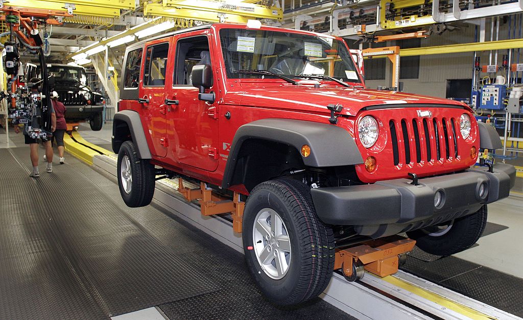 A Jeep Wrangler with a hard top on the assembly line