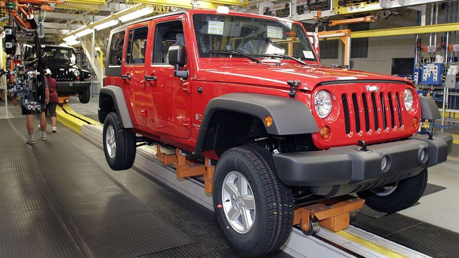 A Jeep Wrangler with a hard top on the assembly line
