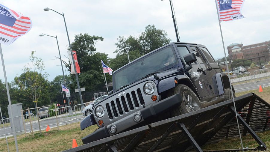 People test drive a Jeep Wrangler around a course