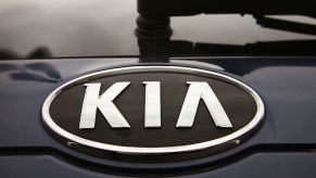 The logo on a Kia Sedona for sale at a Kia dealership.