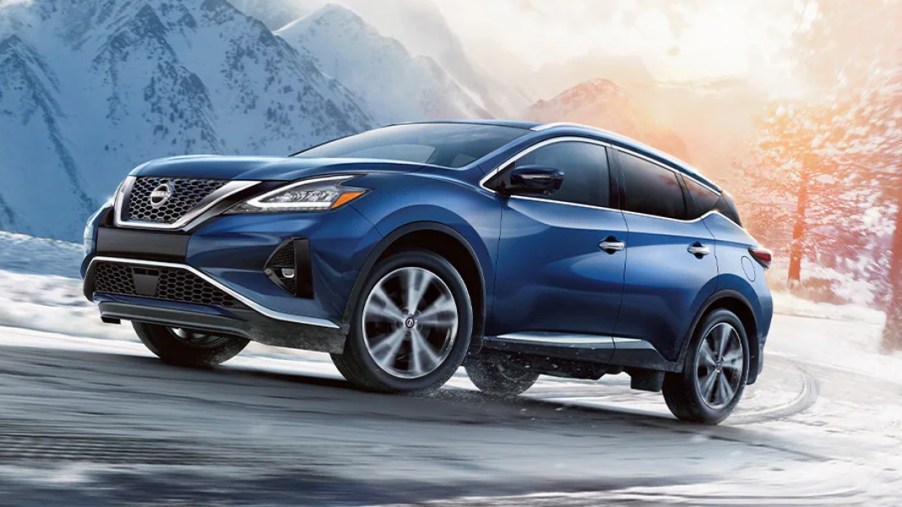 A blue Nissan Murano midsize SUV is driving.