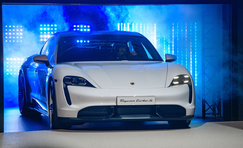 A Porsche Taycan at a reveal event for the car