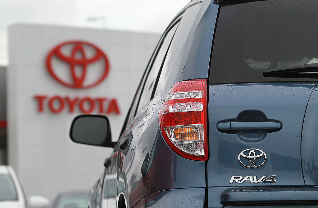 A Toyota RAV4 parked in a dealership lot with other cars