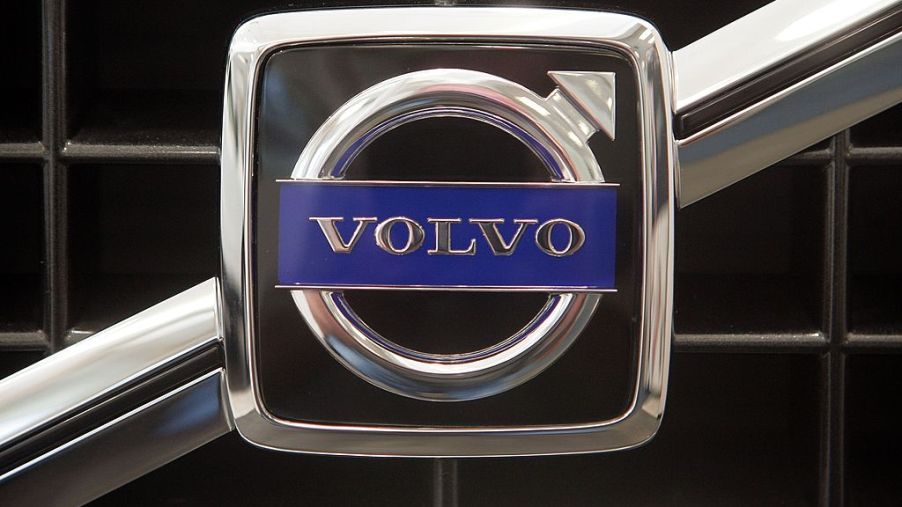 A Volvo logo on the front of a new car
