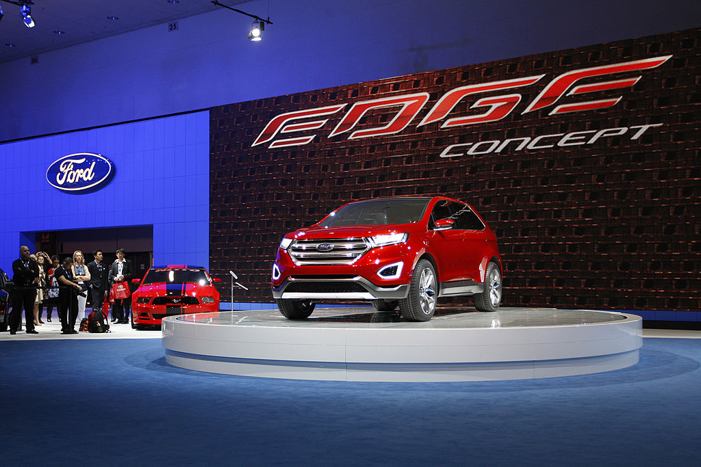 People watch a presentation of the Ford Edge concept vehicle during media preview days at the 2013 Los Angeles Auto Show on November 20, 2013
