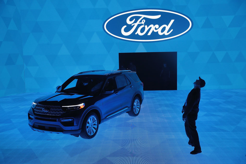 Workers prepare for a demonstration featuring the new 2020 Ford Explorer at the North American International Auto Show