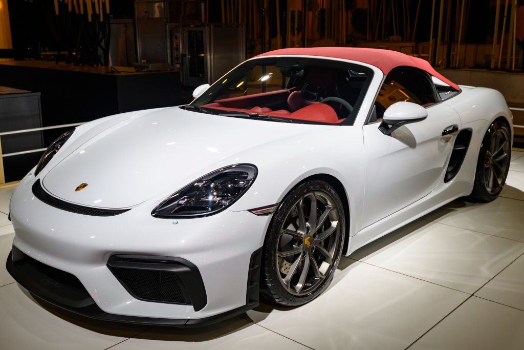 white 718 Porsche convertible with red top