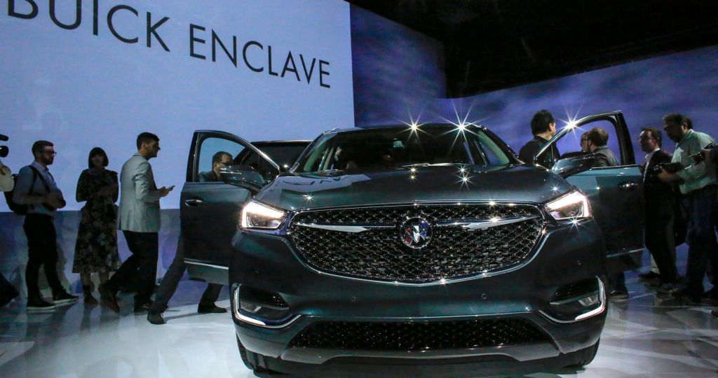 People watch the new Car Buick Enclave Avenir after it was revealed on April 11, 2017 in New York