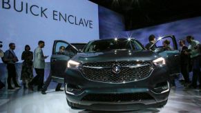 People watch the new Car Buick Enclave Avenir after it was revealed on April 11, 2017 in New York