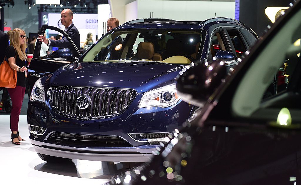 People inspect the 2015 Buick Enclave on display at the LA Auto Show's press and trade day in Los Angeles, California on November 19, 2014